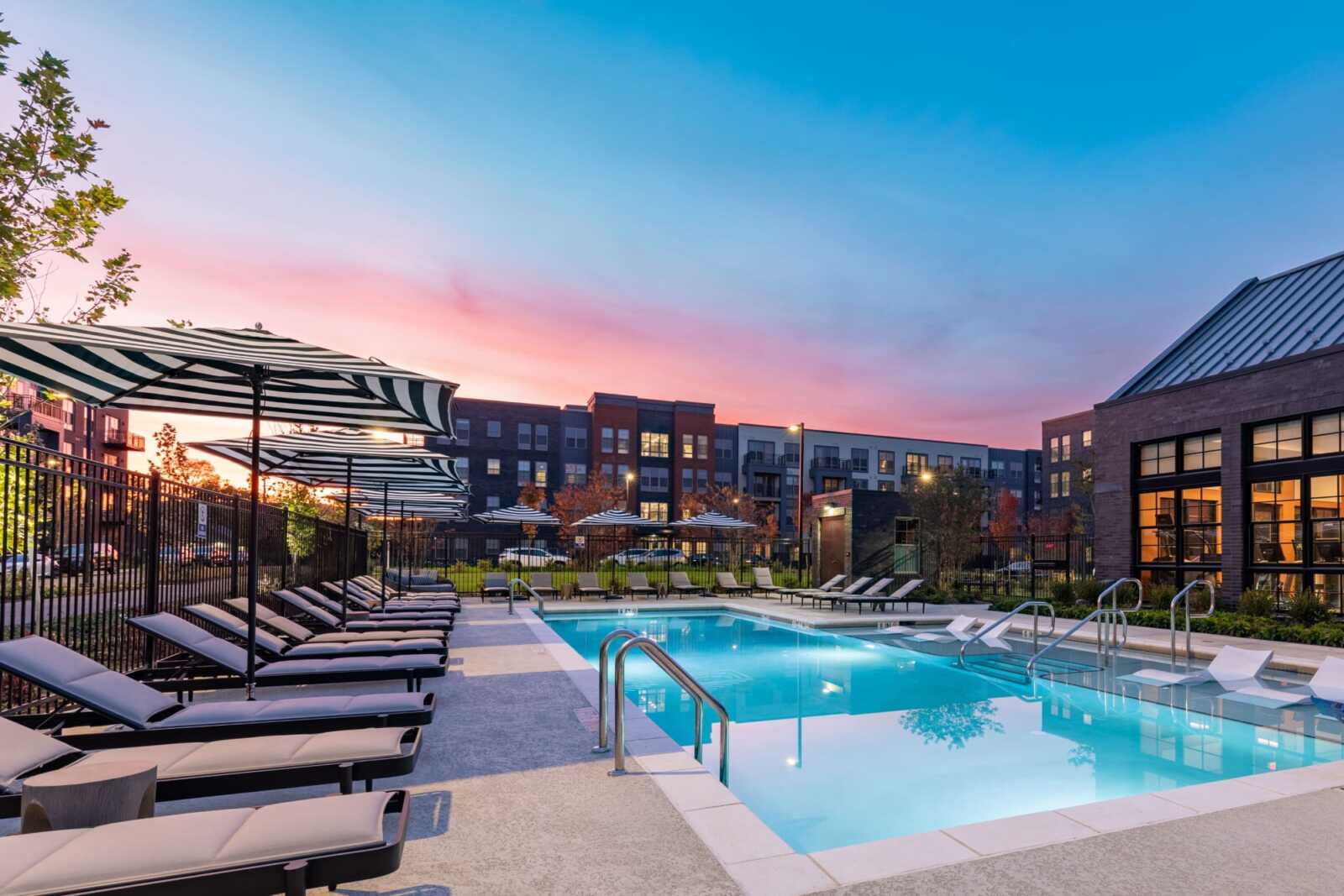Resort-style swimming pool with sun shelf and daybeds at EDE Downtown Frederick, Maryland apartments
