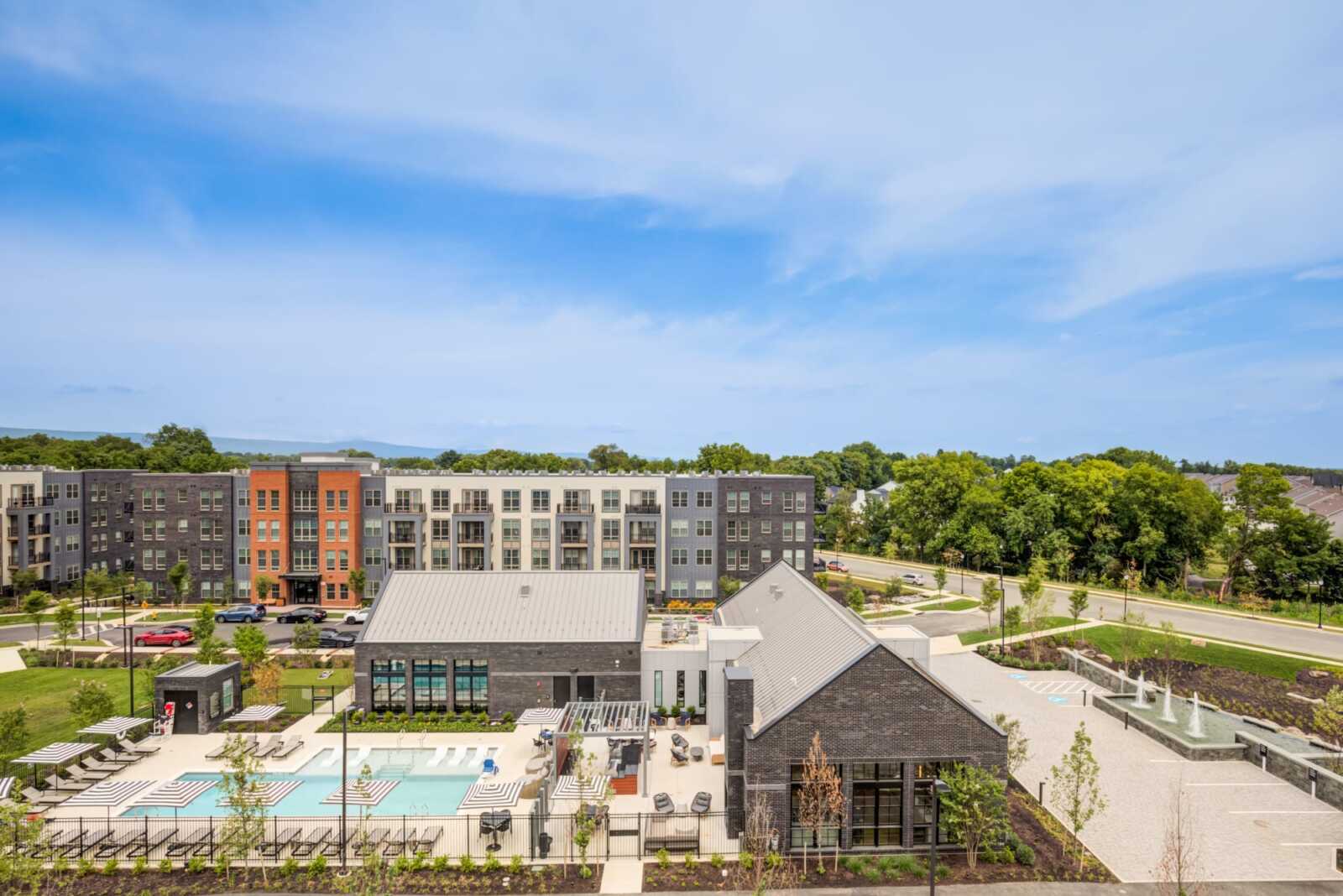 Aerial view of Clubhouse, resort swimming pool and EDE apartment community in Downtown Frederick